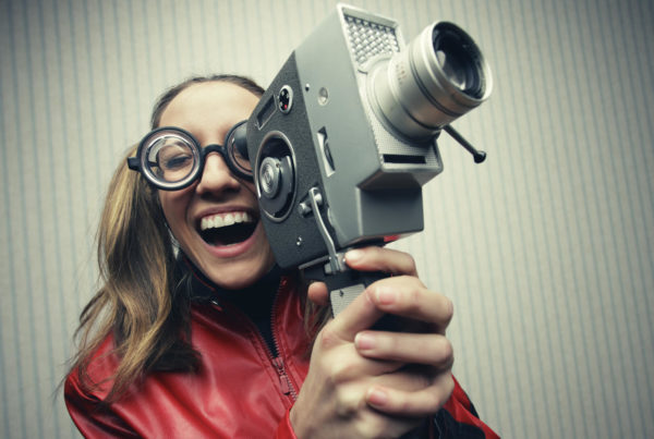 woman holding old video camera